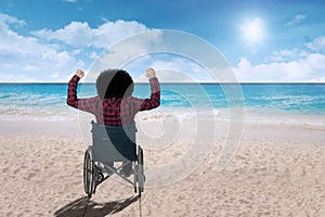 Disabled person in a wheelchair at beach