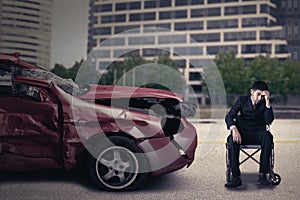 Disabled person with wheelchair and damaged car