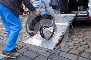 Disabled person on wheelchair using car lift