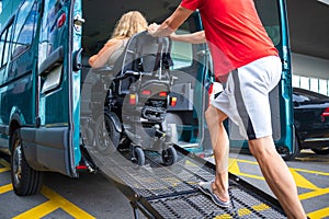 Disabled person on wheelchair using van ramp