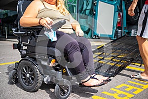 Disabled person on wheelchair using van ramp