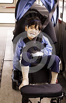 Disabled preschool boy in wheelchair on bus