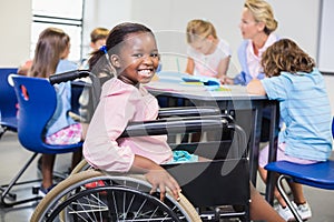 Disabled schoolgirl smiling in classroom