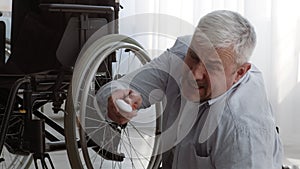 Disabled Senior Man Lying On Floor Pushing Emergency Button Indoor