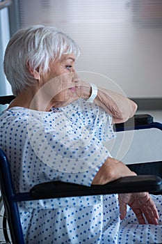 Disabled senior patient on wheelchair in hospital passageway