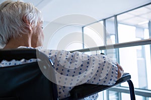 Disabled senior patient on wheelchair in hospital passageway at hospital