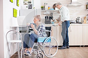 Disabled senior woman working on laptop