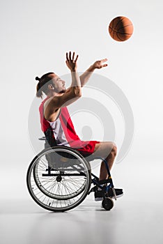 Disabled sportsman throwing basketball