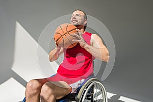 Disabled sportsman throwing basketball