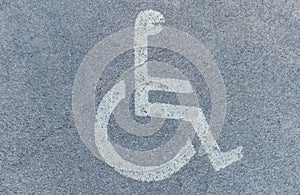 Disabled symbol sign on asphalt in parking space. International markings for a handicapped parking