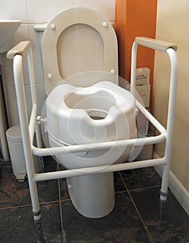 Disabled toilet with handles and raised seat photo