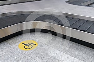 Disabled travellers icon at baggage claim area in empty airport