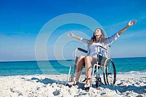 Disabled woman with arms outstretched at the beach