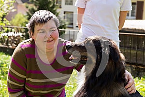 Disabled woman is caress a dog