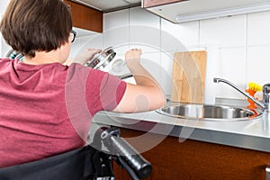 Disabled woman cooking in the kitchen