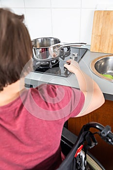 Disabled woman cooking in the kitchen