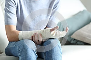 Disabled woman grabbing her painful bandaged arm