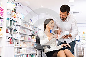 Disabled woman and her husband choosing medicine