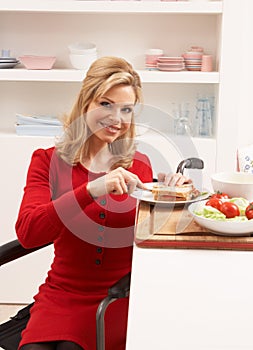 Disabled Woman Making Sandwich In Kitchen