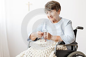 Disabled woman praying for health