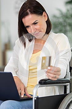 disabled woman shopping online sitting on wheelchair