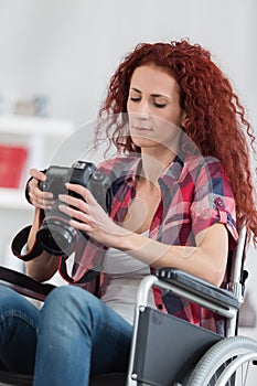 Disabled woman taking pictures with dslr camera