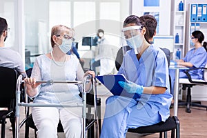 Disabled woman using walking frame