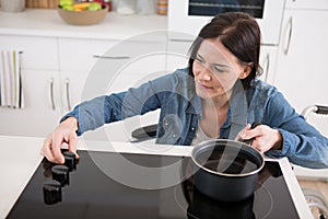 disabled woman in wheelchair cooking on hob