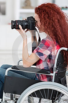 Disabled woman in wheelchair have passion for photography