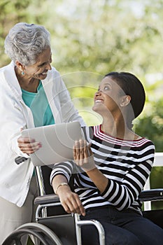 Disabled woman in a wheelchair with her mother