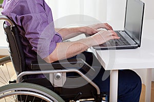 Disabled working on laptop photo