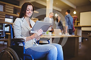 Disabled young businesswoman using digital tablet