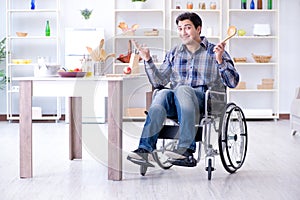 The disabled young man husband workin in kitchen