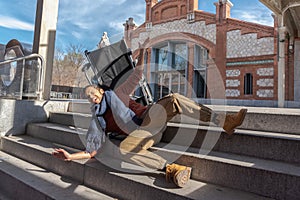 Disabled young man in a wheelchair falls down some stairs