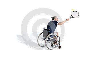 Disabled young sportsman in wheelchair playing tennis