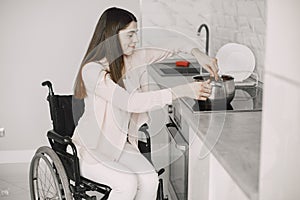 Disabled Young Woman Cooking In Her Kitchen