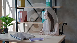 Disabled young woman talking to collegue at office