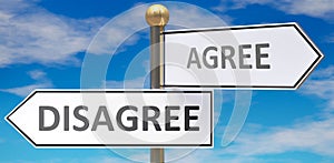 Disagree and agree as different choices in life - pictured as words Disagree, agree on road signs pointing at opposite ways to