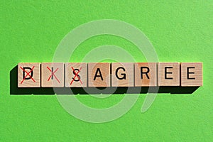 Disagree, word in 3d wood alphabet letters on green background