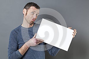 Disapointed man holding balnk white card for advert