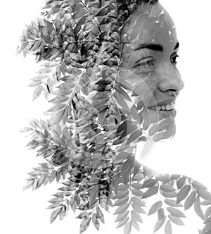 A disappearing black and white double exposure portrait of a smiling woman