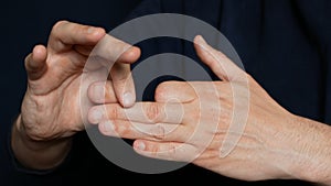 Disappearing finger phalanx. Man is doing a trick with hands. Showing a magic trick