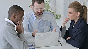 Disappointed Business People having Loss while using Laptop in Office