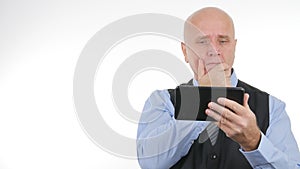 Disappointed Businessman Reading Bad News From a Touch Tablet