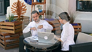 Disappointed businessman tearing up a document, contract or agreement in cafe