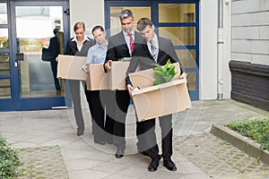 Disappointed Businesspeople With Cardboard Boxes