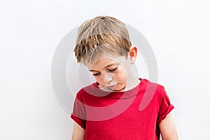 Disappointed child looking down expressing solitude, disillusion or parent problems