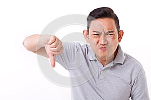 Disappointed, frustrated man giving thumb down gesture