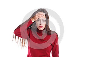 Disappointed girl, holds hand to forehead due to an embarrassing situation. Isolated on white.