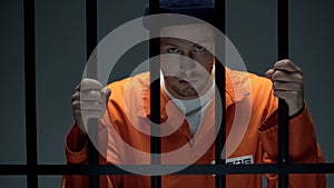 Disappointed male prisoner holding cell bars, losing hope for amnesty, justice photo